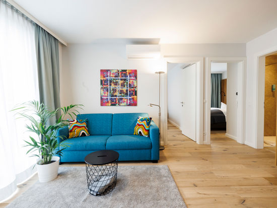 The living room in the Apartment with sofa, table, plant and much more.