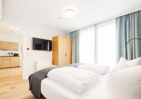 The modern bedroom in the Deluxe Plus Apartment.