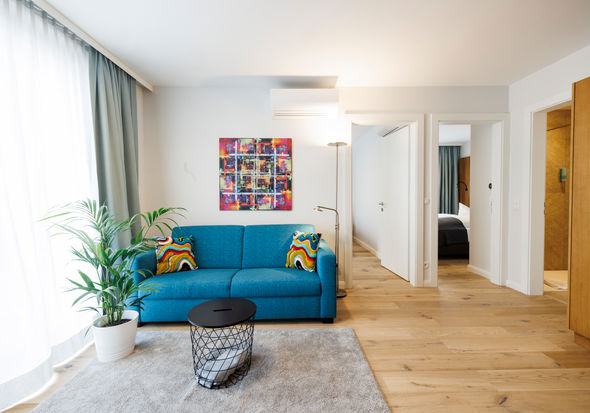 The living room in the Apartment with sofa, table, plant and much more.