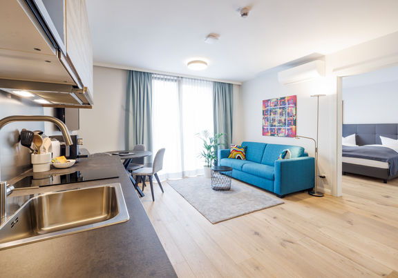 The modern kitchen-living room in the Deluxe Plus Apartment.