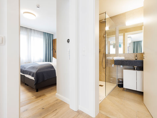 The bedroom and bathroom are separated by a door.