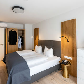 The modern bedroom with wardrobe and double bed in the Deluxe XL apartment.