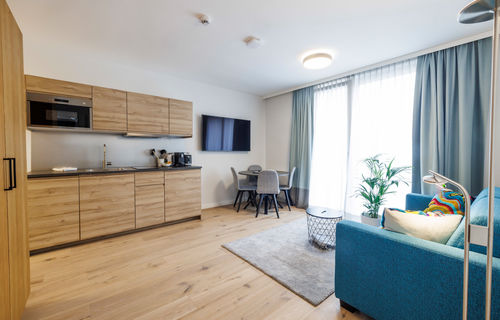 The modern, fully equipped kitchen-living room in the Deluxe Plus Apartment.