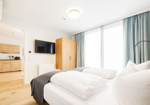 The modern bedroom in the Deluxe Plus Apartment.