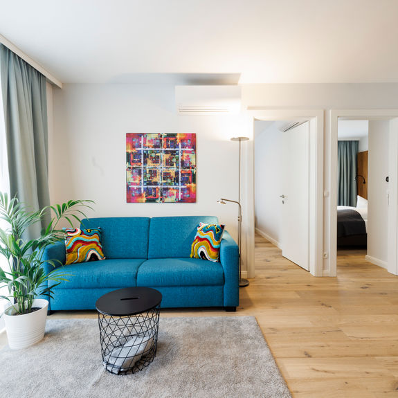 The living room in the Apartment with sofa, table, plant and much more.
