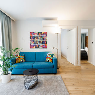 The living room in the Apartment with sofa, table, plant and much more.