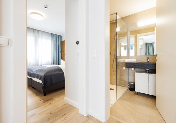 The bedroom and bathroom are separated by a door.