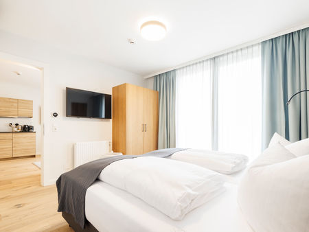 The modern bedroom in the Deluxe Plus Apartment.