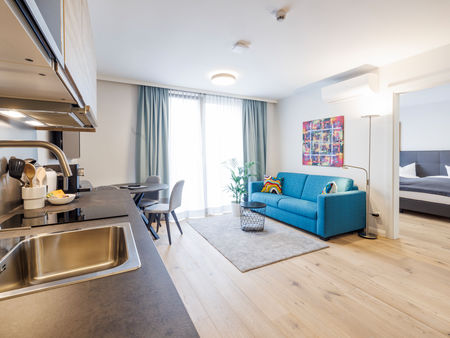 The modern kitchen-living room in the Deluxe Plus Apartment.