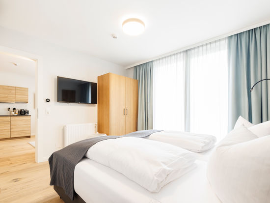 The modern bedroom in the Deluxe Plus Apartment.